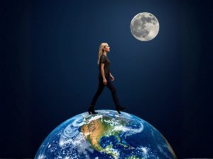 Woman in black walks across a globe, with a full Moon in a dark space background above.